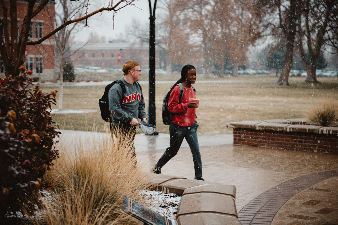 students walking to class with light snowfall