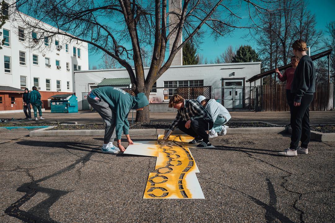 student spray painting on pavement
