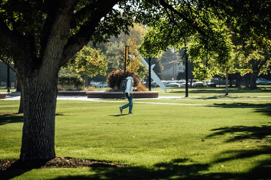 student walking on grass