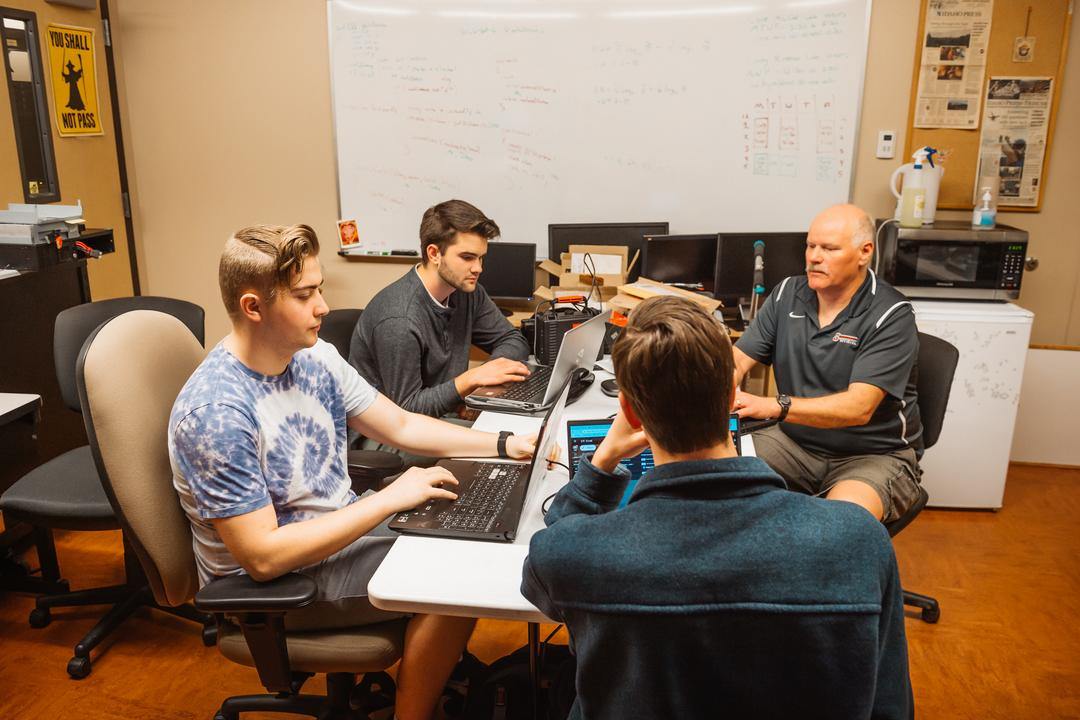 students and professor discussing