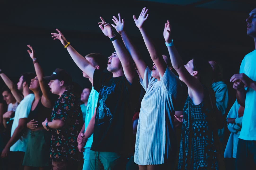 students worshipping together