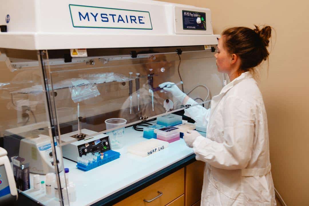 2022_Science_Shoot_July_Edits-42 student putting syringe into test vials