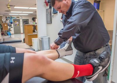 athletic trainer working on athlete