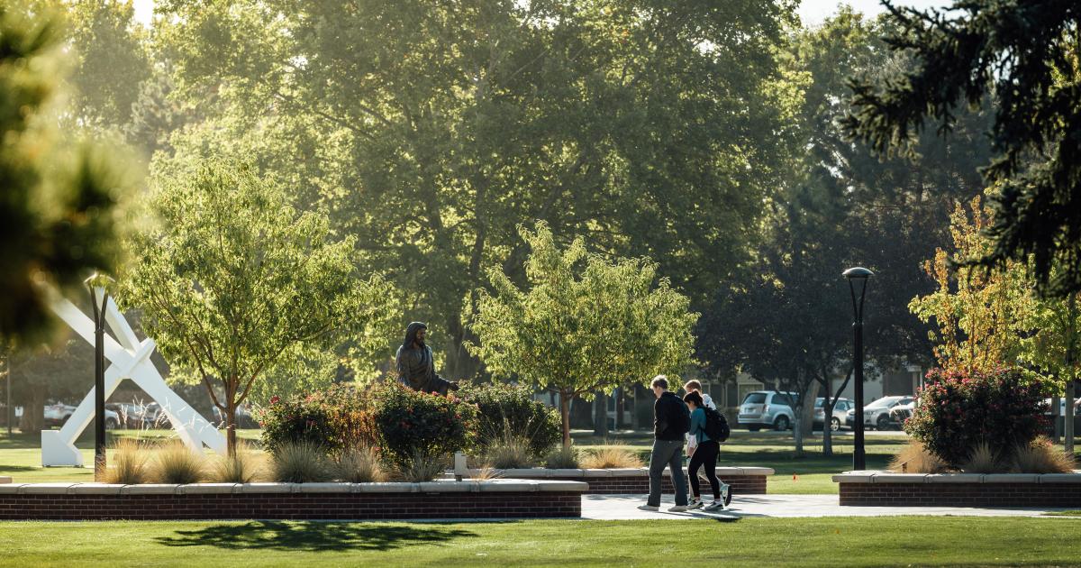 Students walking during a sunny day on campus