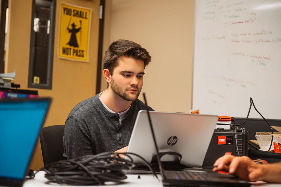 students on laptops in lab classroom. Computer science jobs are abundant with on-campus or online computer science degree programs.