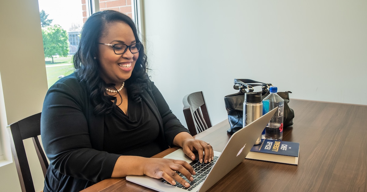 Crasha Townsend, Ph.D. working on a laptop in the Leah Peterson Learning Commons