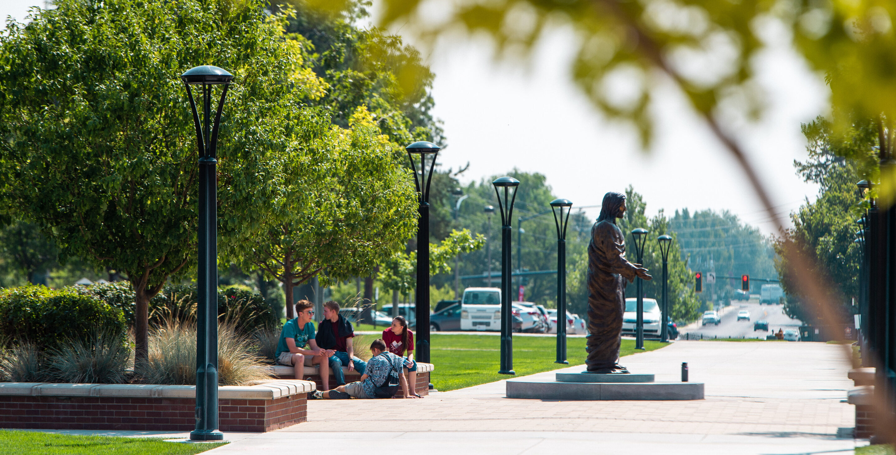 Students sit outside in the Quad in the spring