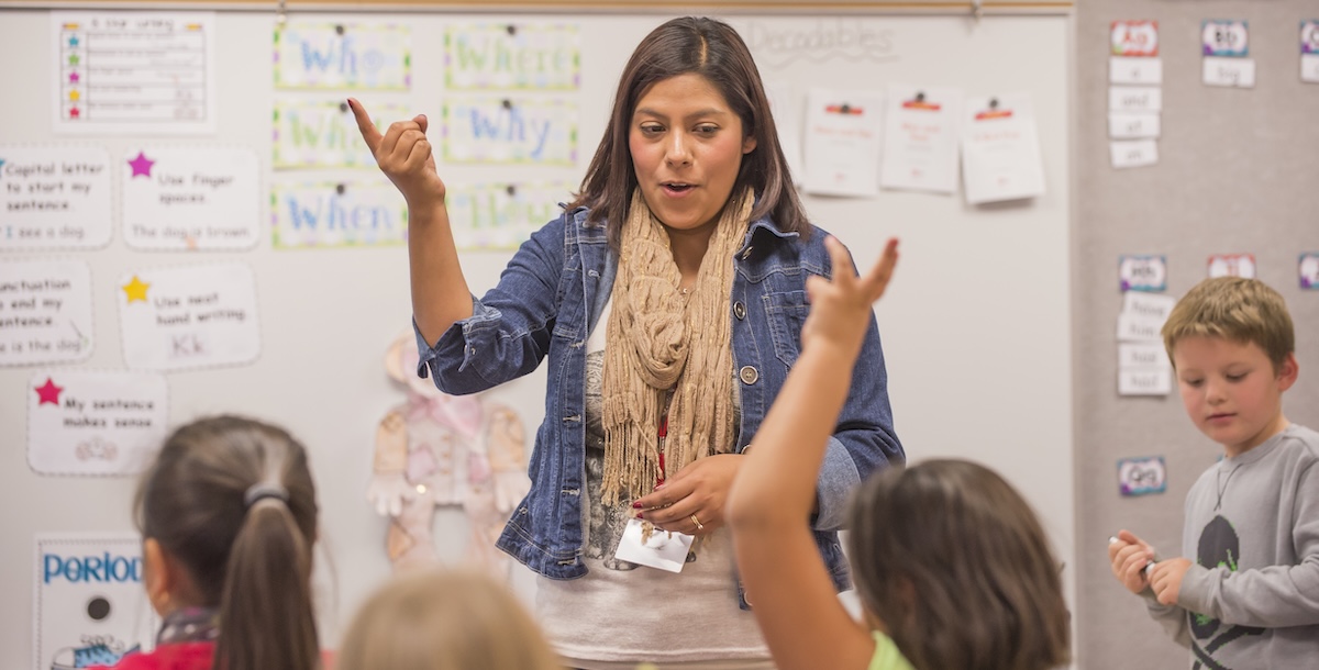 Teacher teaching to a classroom of young students