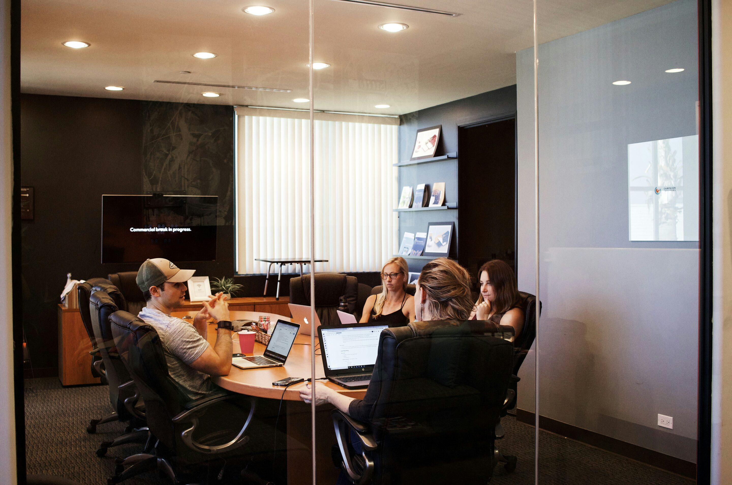 Org Management Boardroom with business associates sitting around a table and talking
