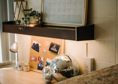 Sutherland room picture; desk with shelf, end of the bed