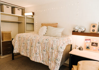 Sutherland room picture; bed with desk, shelf and closet