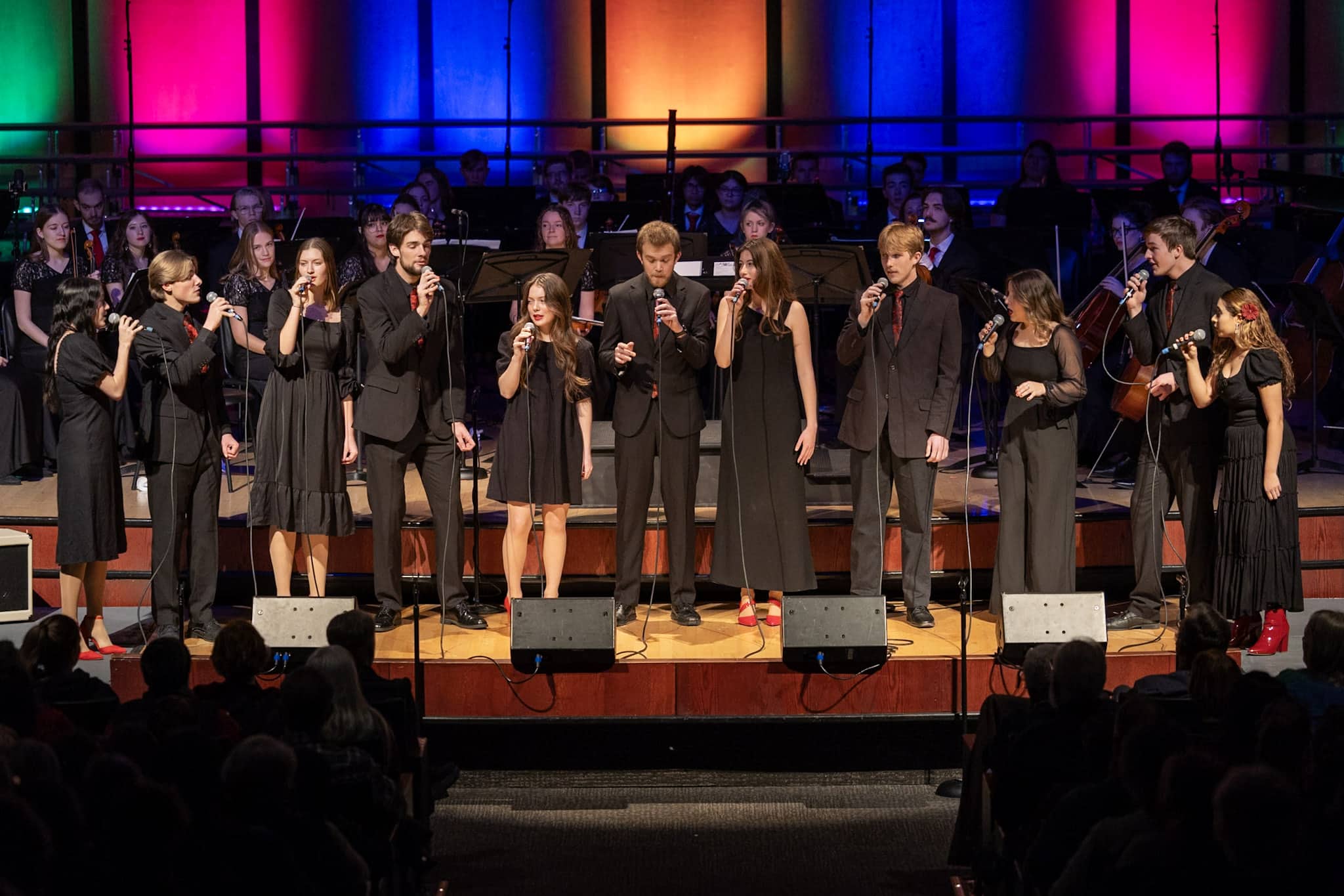 student walking on sidewalk with tote bag