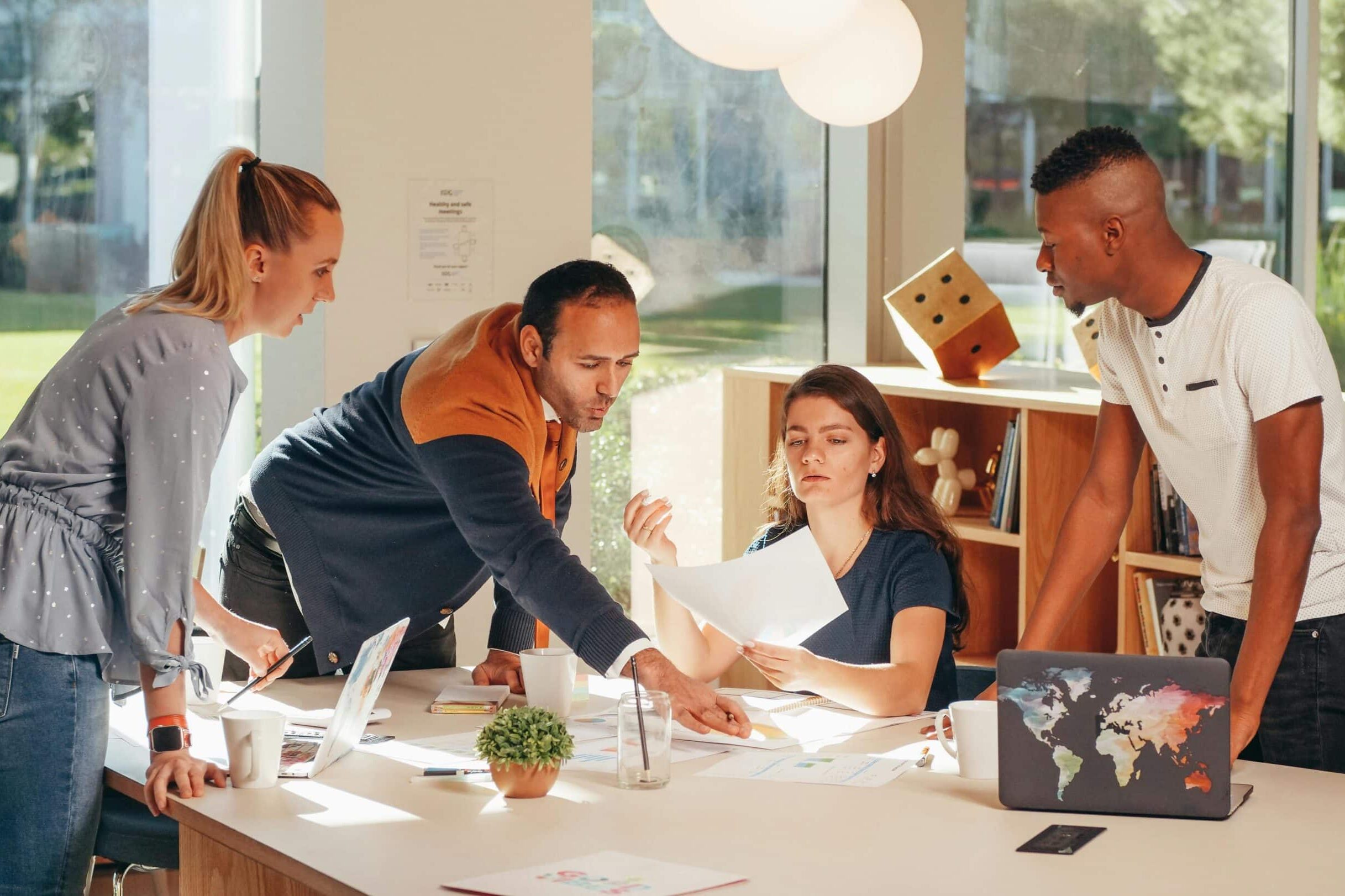 students helping another student pick the best cover design for a book