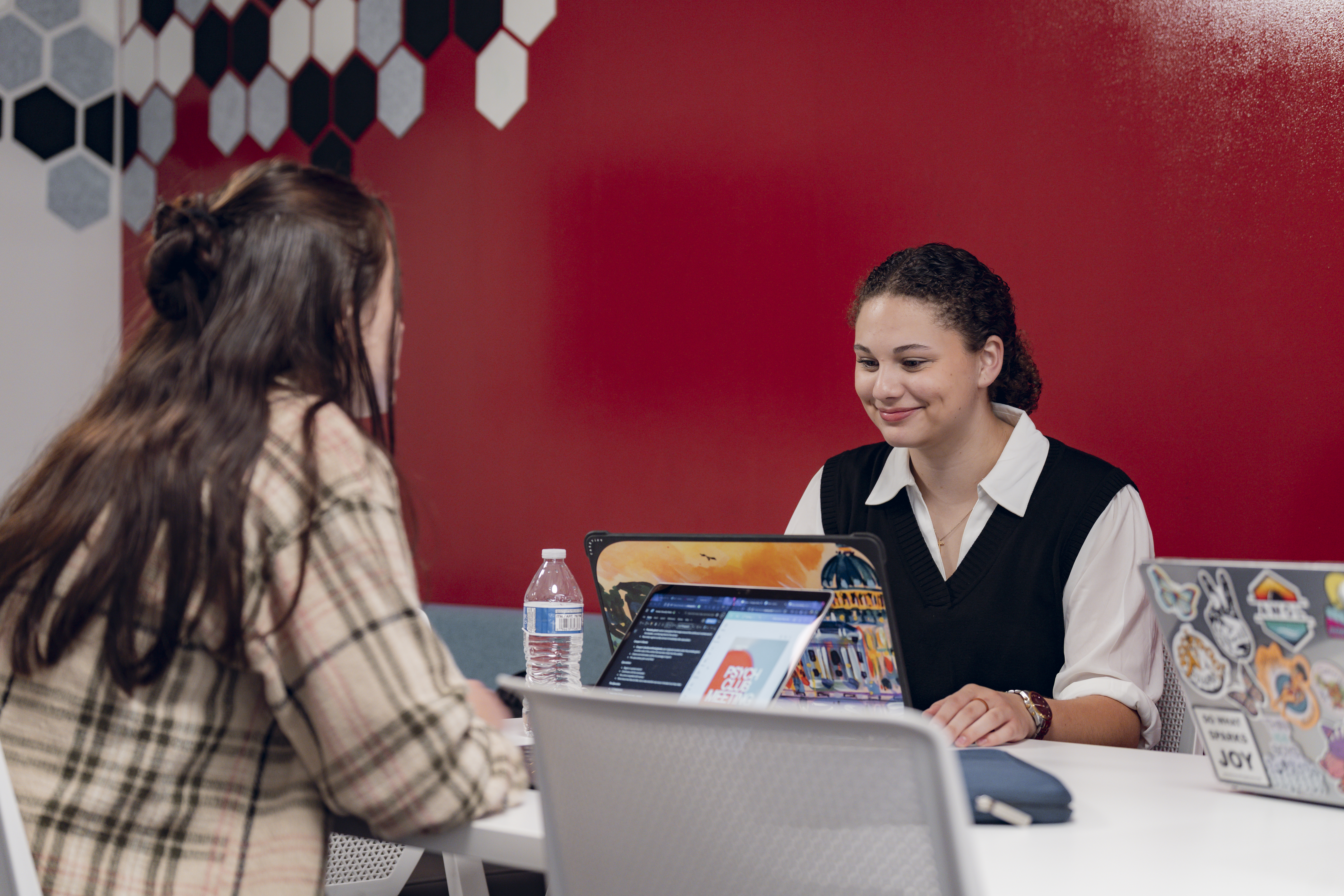 Female students working on computers in a class