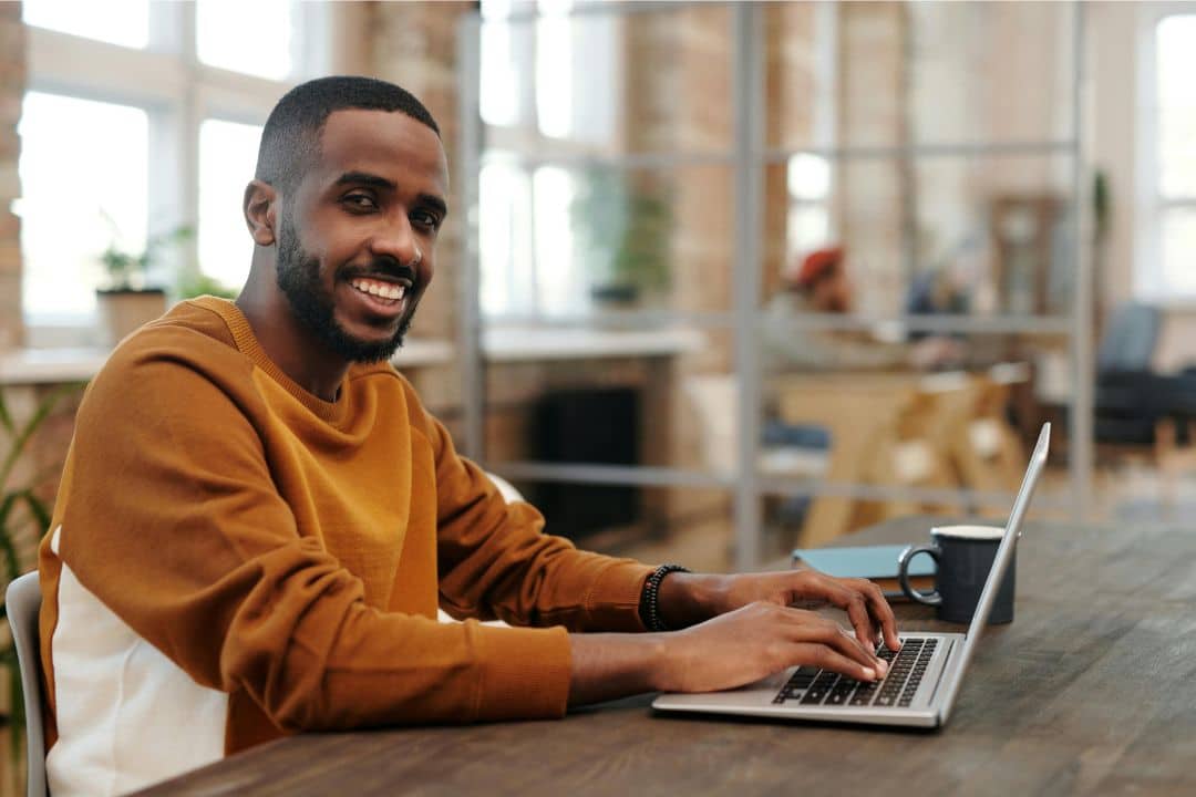 Male student taking classes online from an office