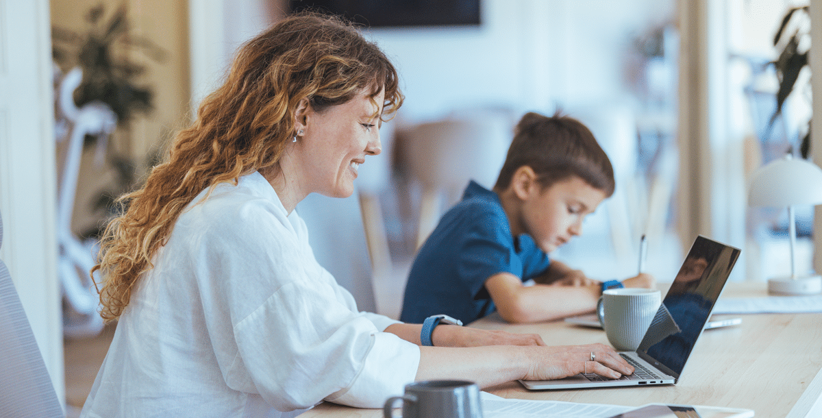 Female working on computer with child next to her