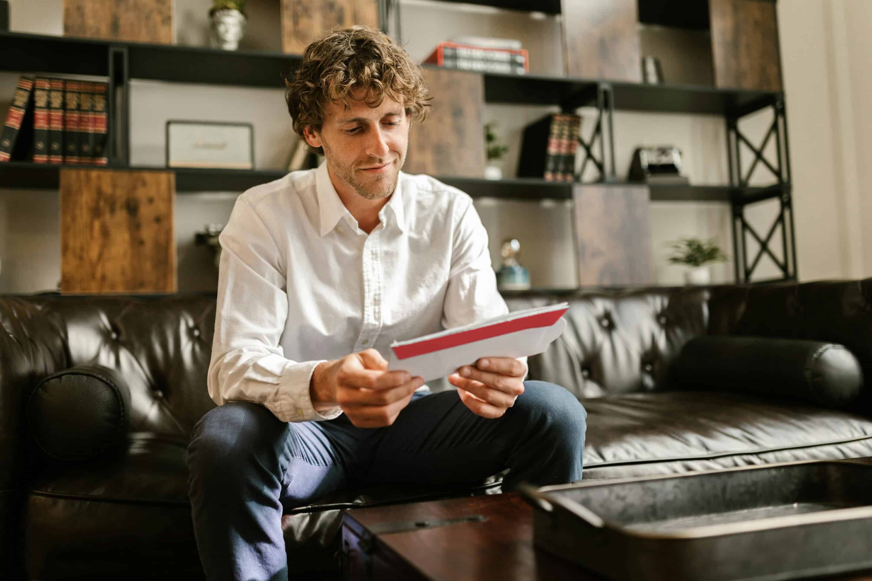 Male business man opening up information from his home