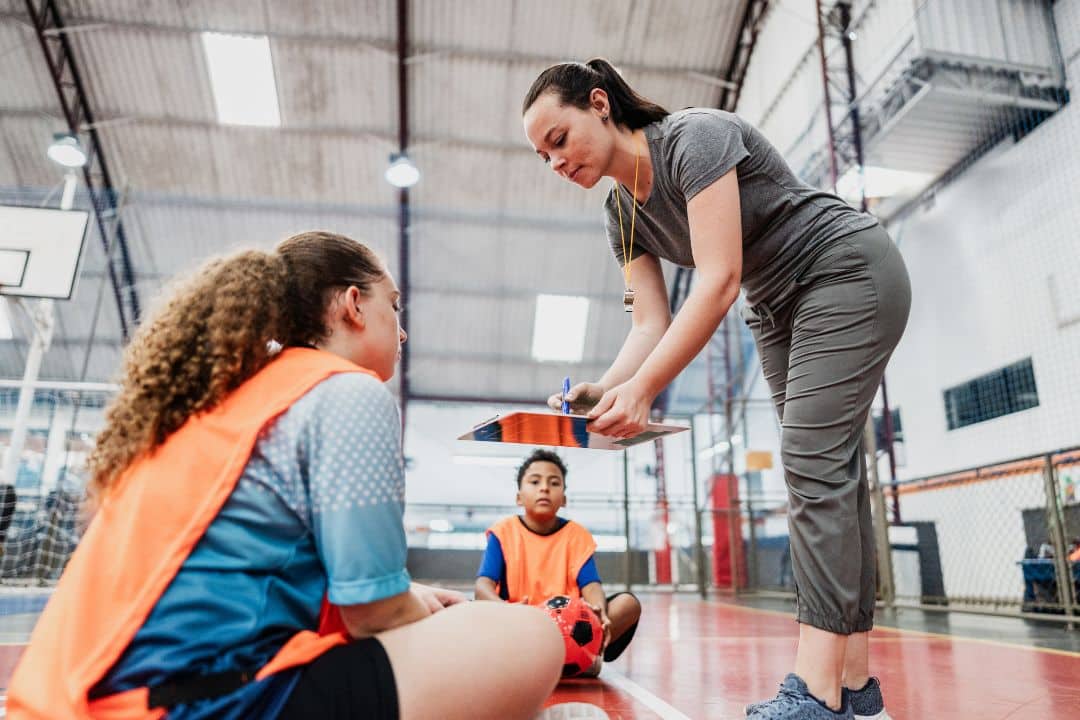 Female Athletic Trainer working with students