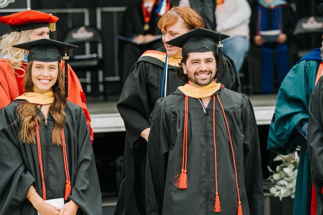 Hooding an Adult Female and Male at Commencement