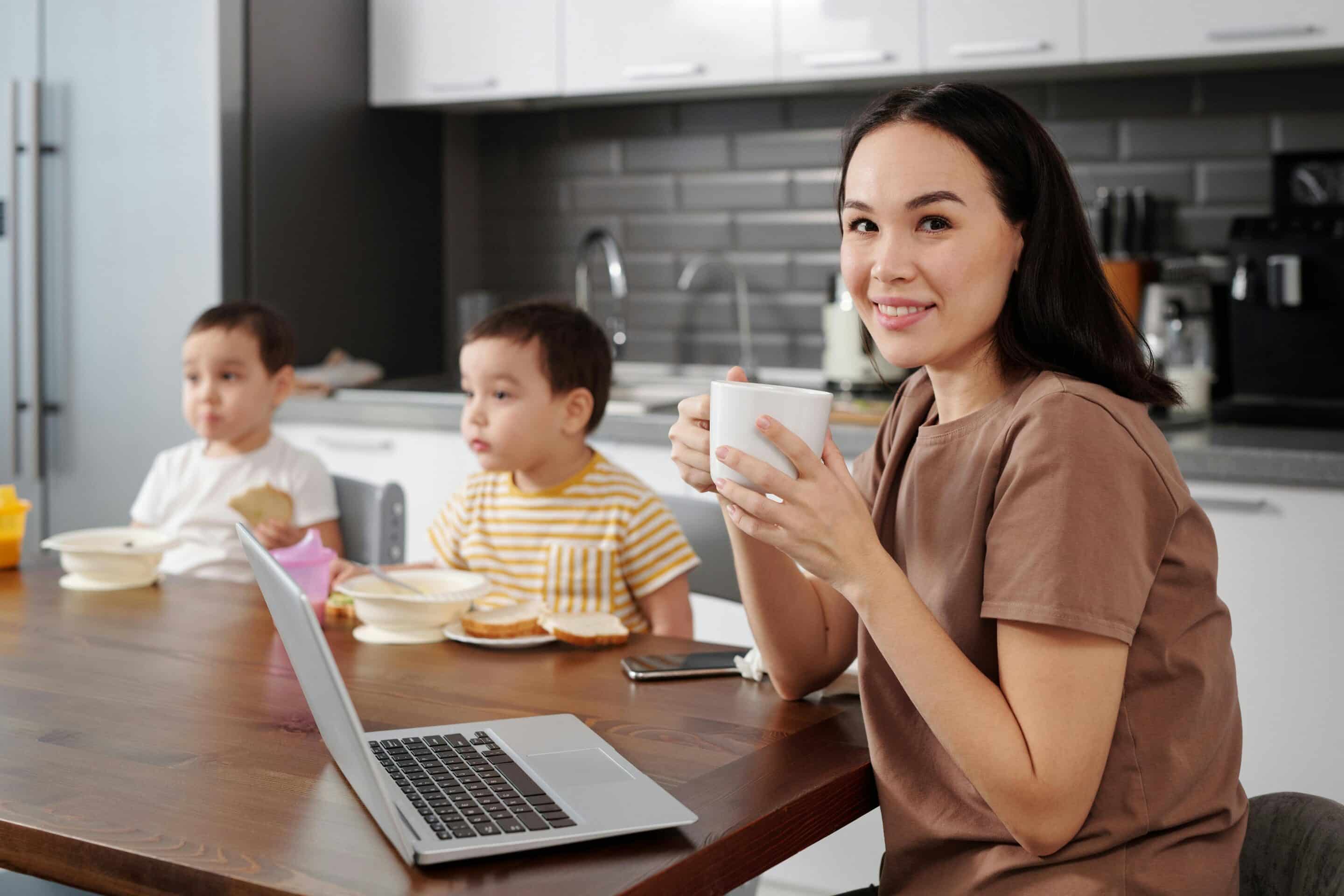 Mom at home with children doing online schooling