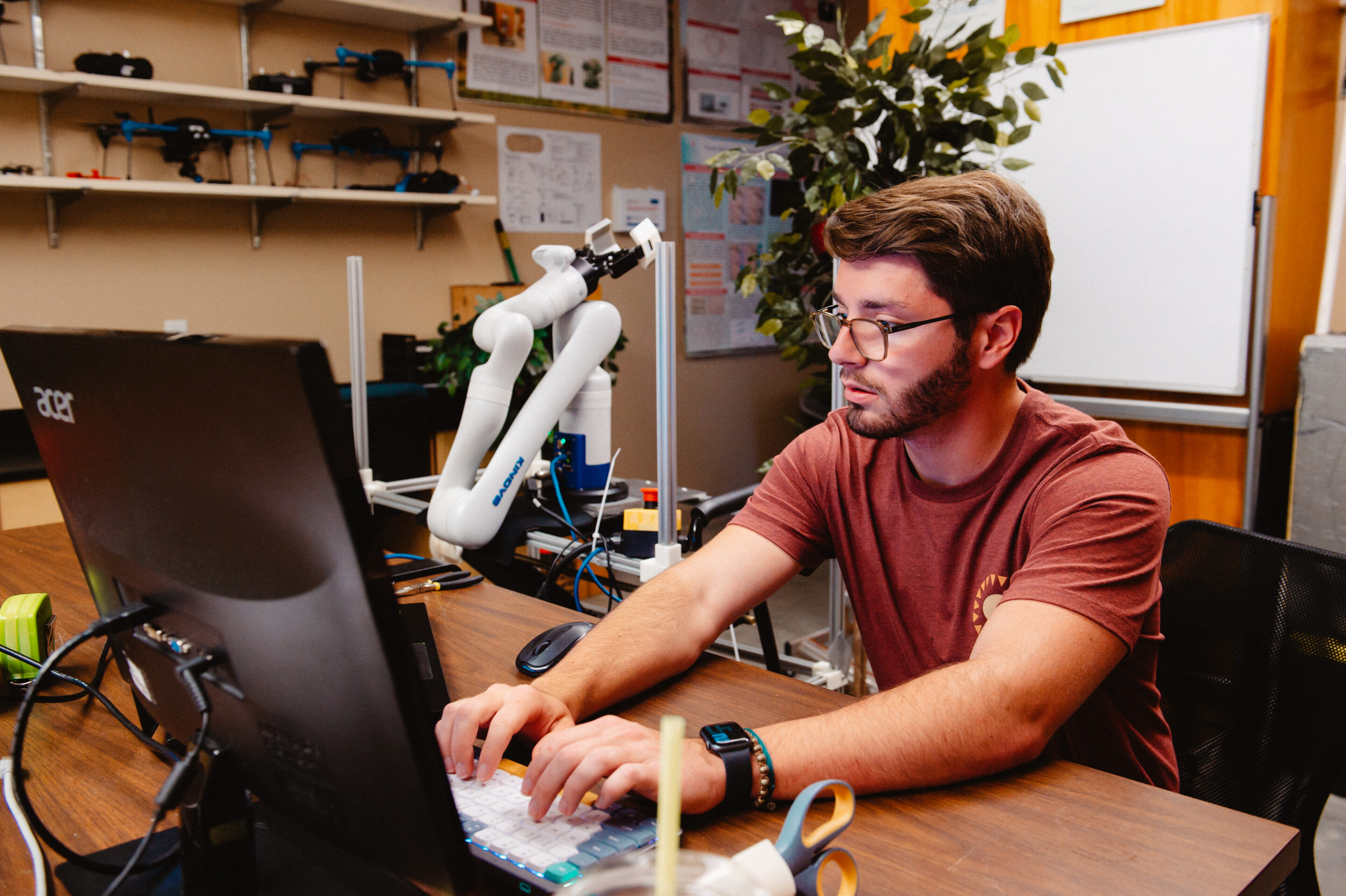 Student working on programming a robotic arm