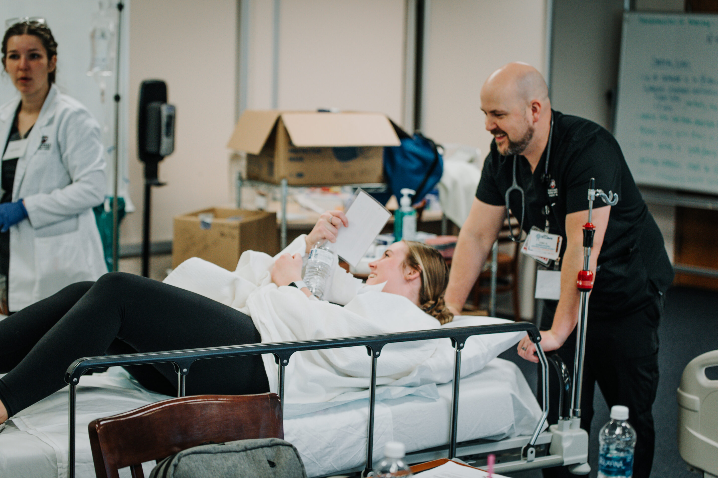 nursing student and patient during lab.