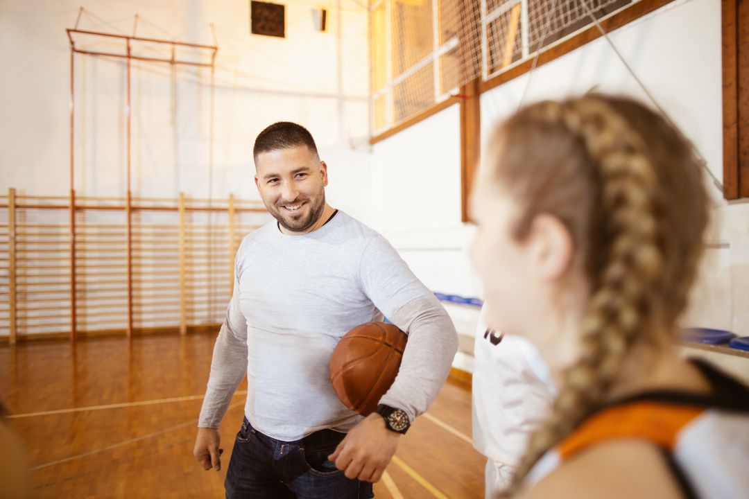 Male Coach in gym working with an athlete
