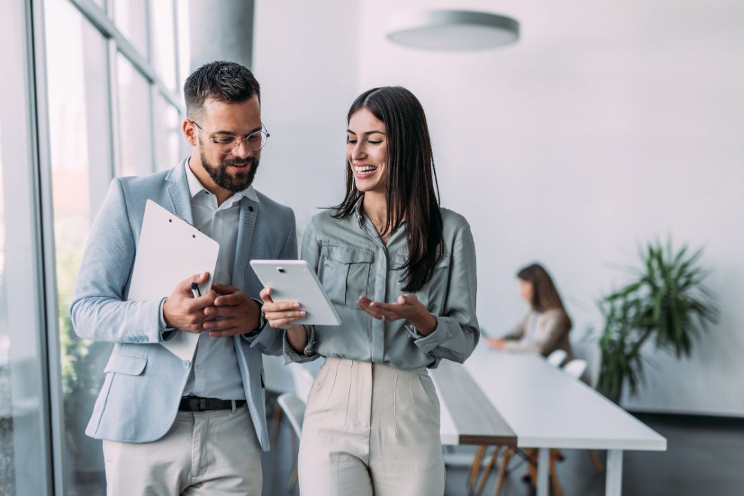 Male and Female colleagues looking over a project