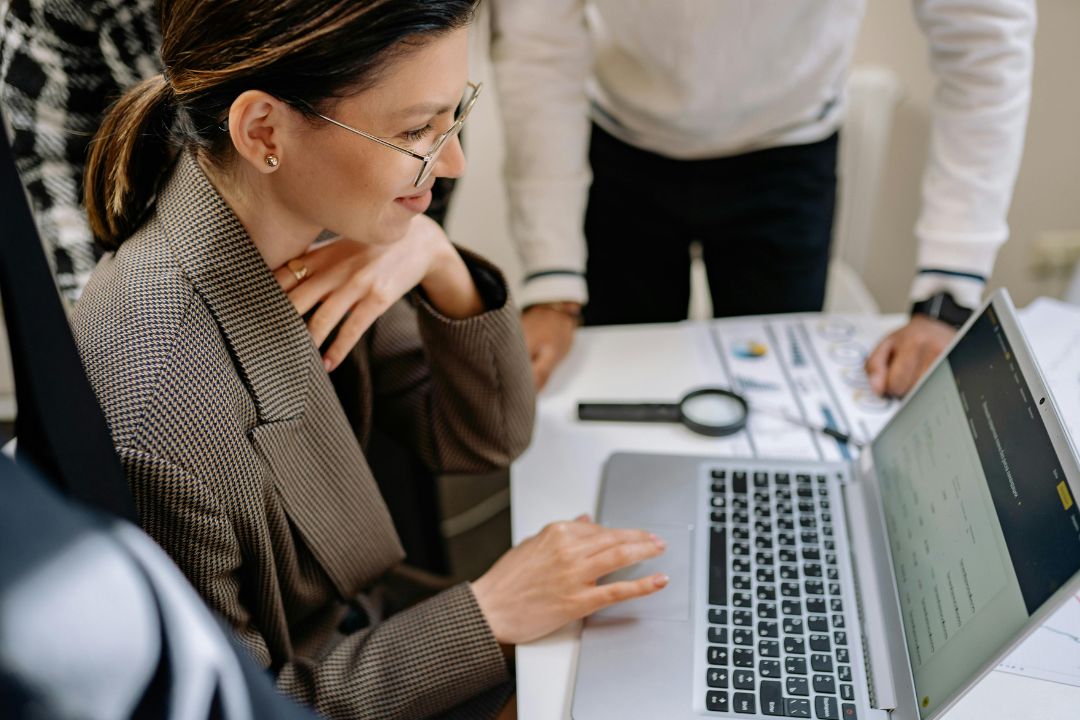 Female professional at computer with business colleagues