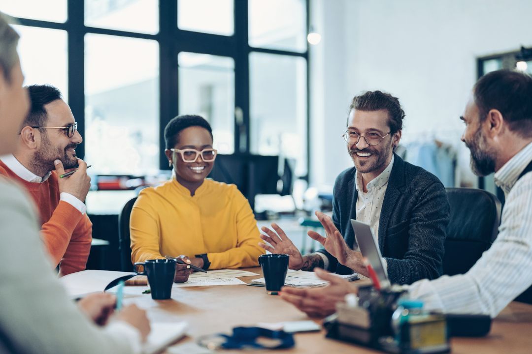 Business meeting with smiling people around the table