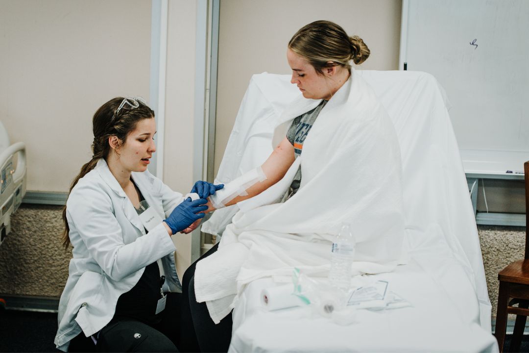 Female Nursing helping a patient
