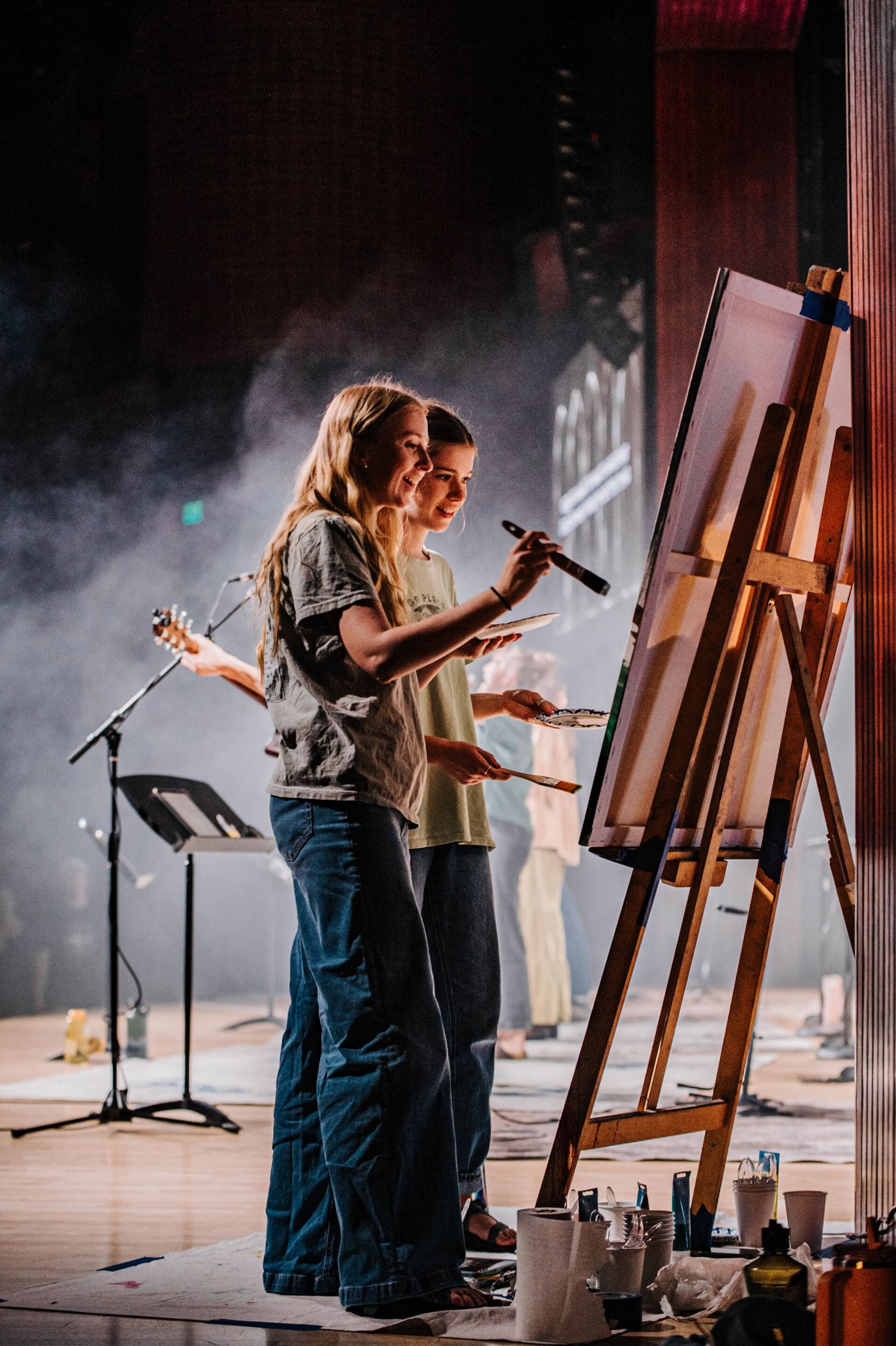 Two students painting during worship