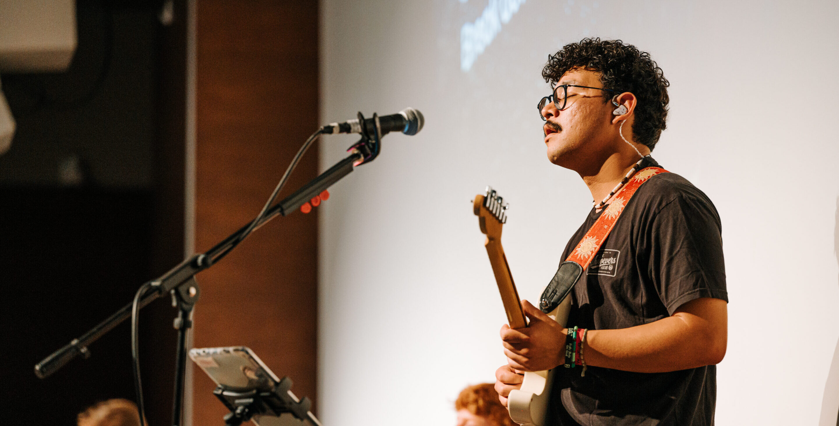albert robles malan playing guitar on stage at timeout worshiping