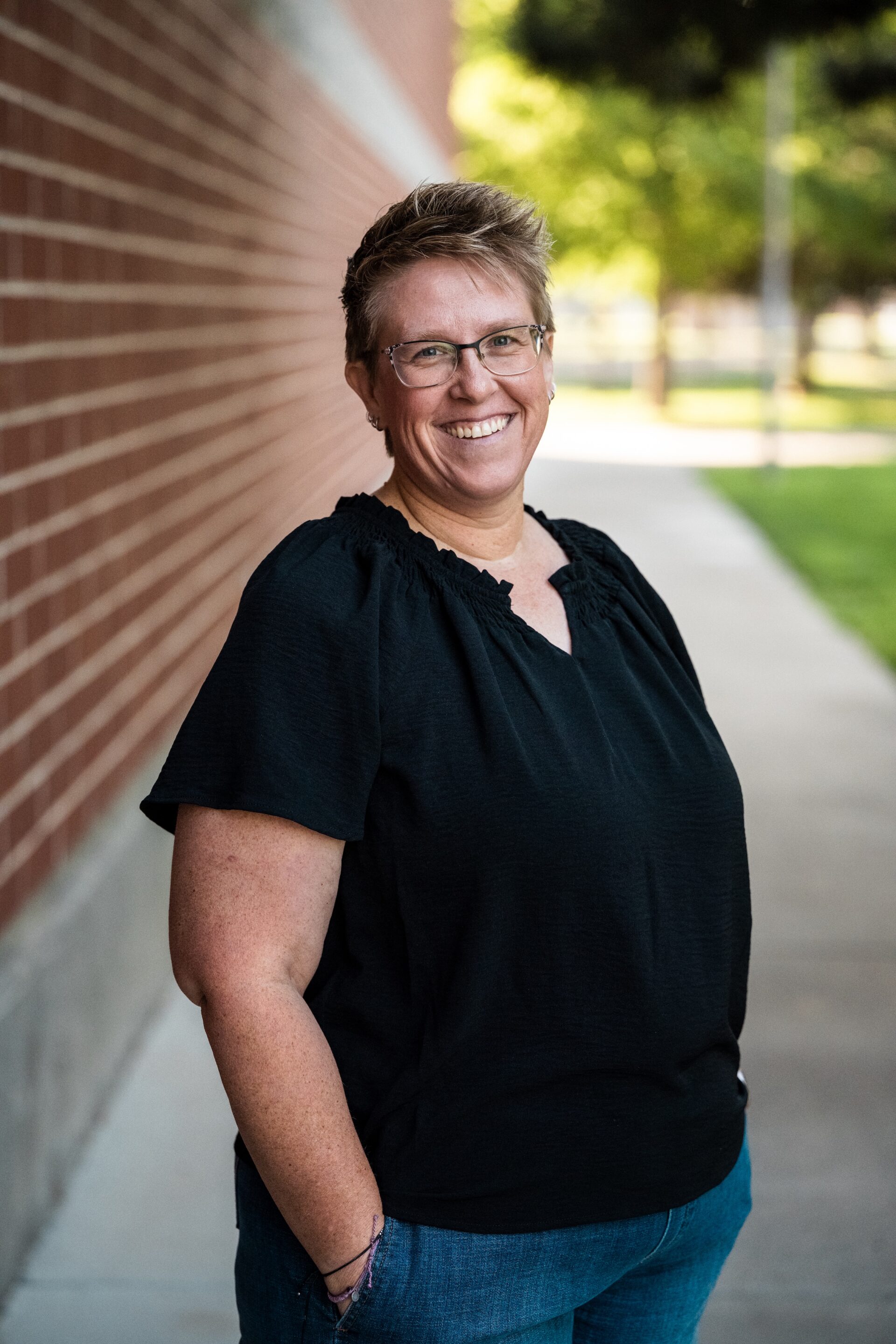 Stacie Knudsen Smiling next to the brandt center