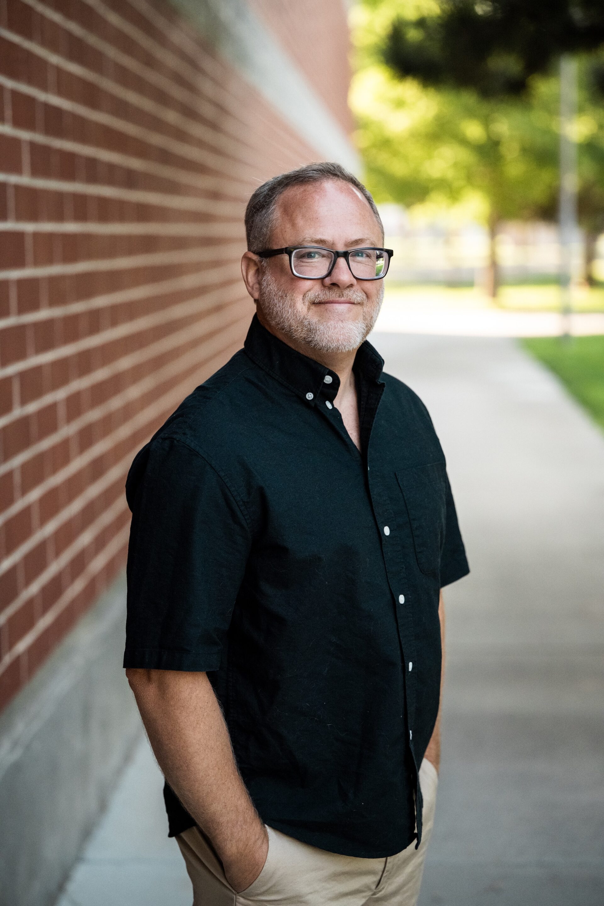 Lance Howard Smiling next to the brandt center