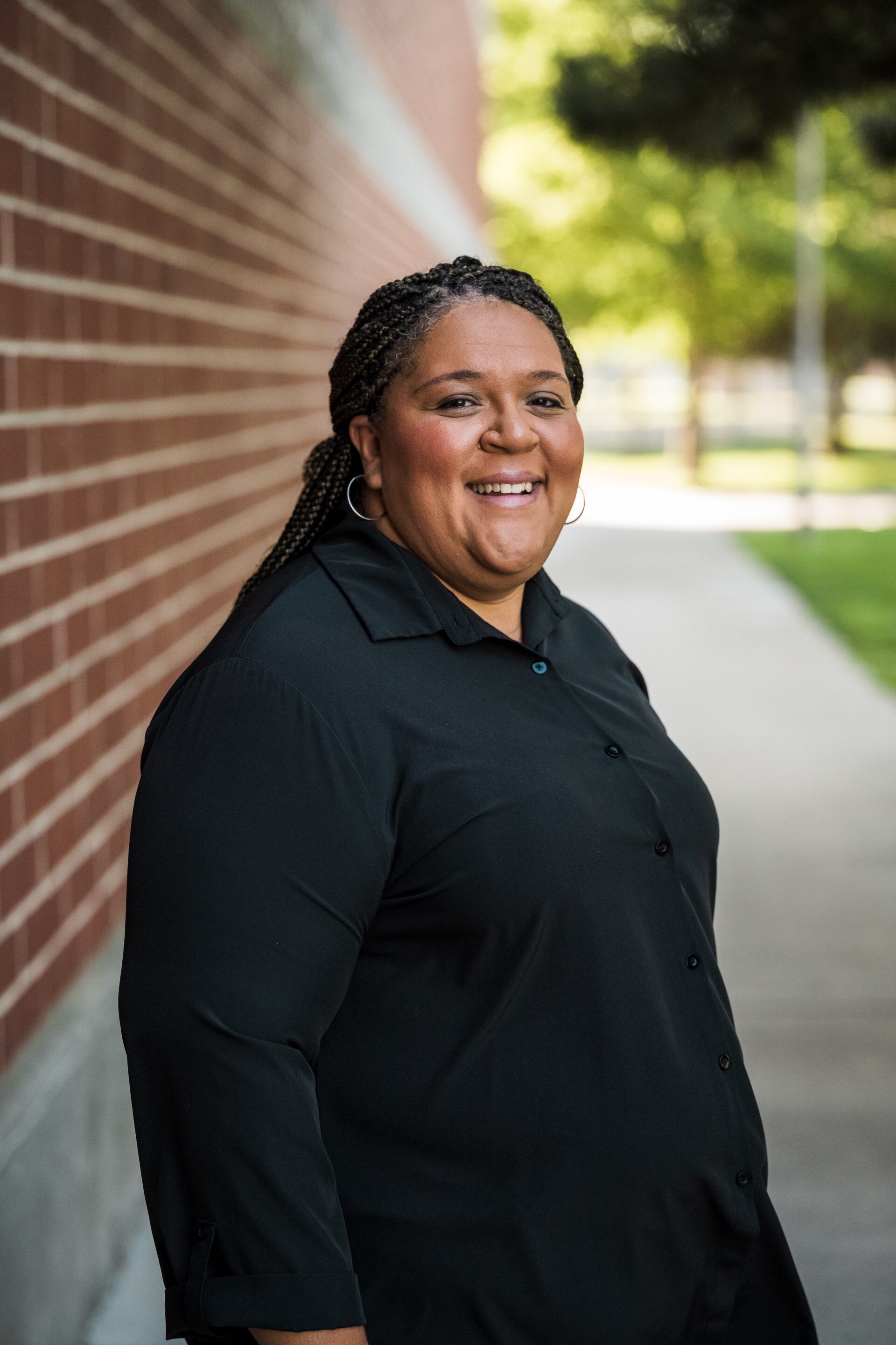 Ashley Gage Smiling next to the brandt center